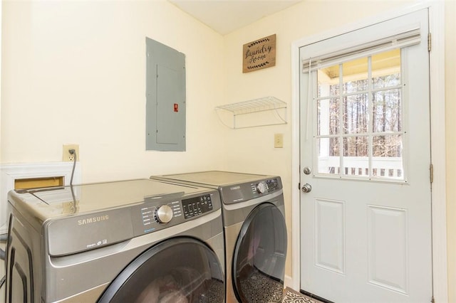 washroom with laundry area, separate washer and dryer, and electric panel