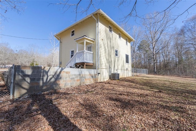 view of home's exterior with central AC and fence