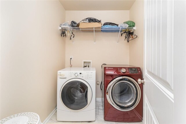 laundry room with laundry area, washer and clothes dryer, and baseboards