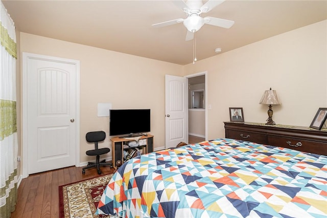 bedroom featuring ceiling fan, baseboards, and wood finished floors