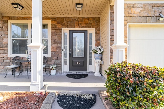 doorway to property with stone siding and a porch