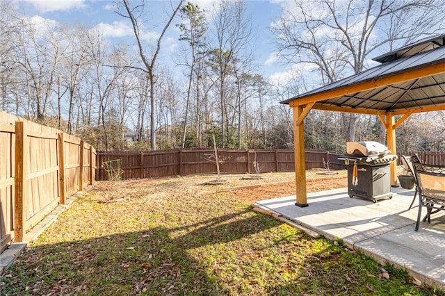 view of yard featuring a patio area, a fenced backyard, and a gazebo