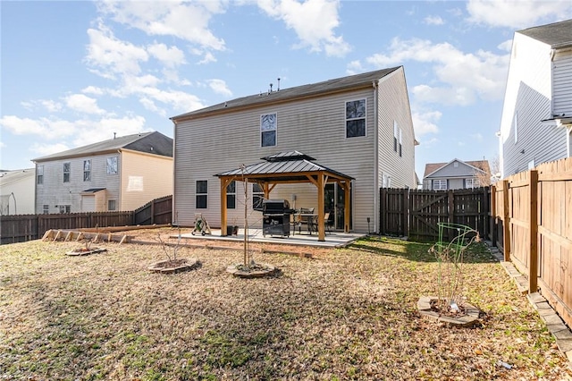 rear view of property with a patio area, a fenced backyard, and a gazebo