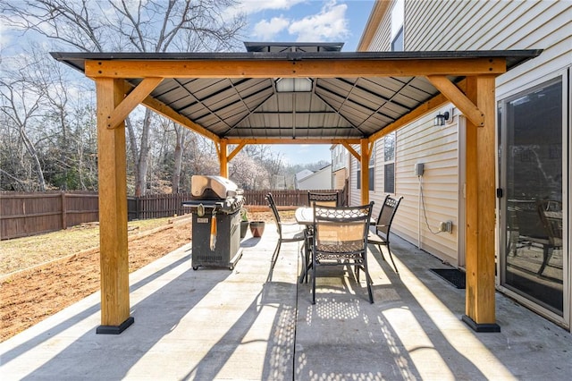 view of patio / terrace featuring a gazebo, outdoor dining space, fence, and area for grilling