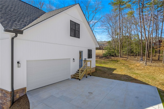 view of property exterior with a garage, driveway, and a shingled roof