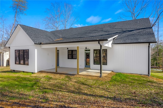 back of house with a patio, a shingled roof, a lawn, and a ceiling fan