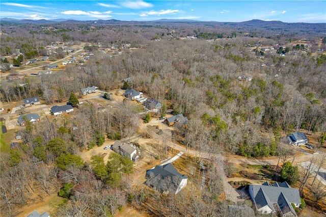 bird's eye view featuring a forest view and a mountain view