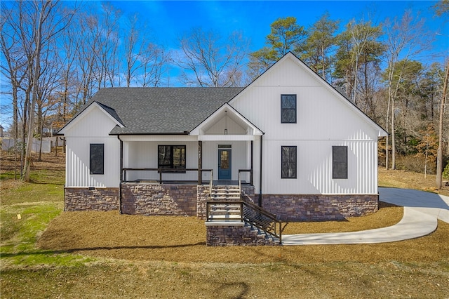 modern inspired farmhouse with driveway, a porch, and a shingled roof