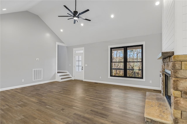 unfurnished living room with ceiling fan, high vaulted ceiling, wood finished floors, and visible vents