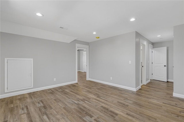 spare room with light wood-style floors, visible vents, baseboards, and recessed lighting