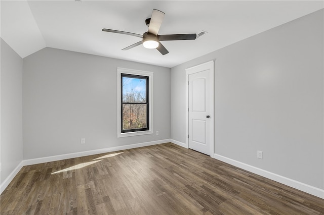 unfurnished room with lofted ceiling, visible vents, ceiling fan, wood finished floors, and baseboards