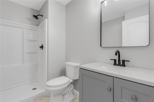 full bathroom featuring a stall shower, marble finish floor, vanity, and toilet