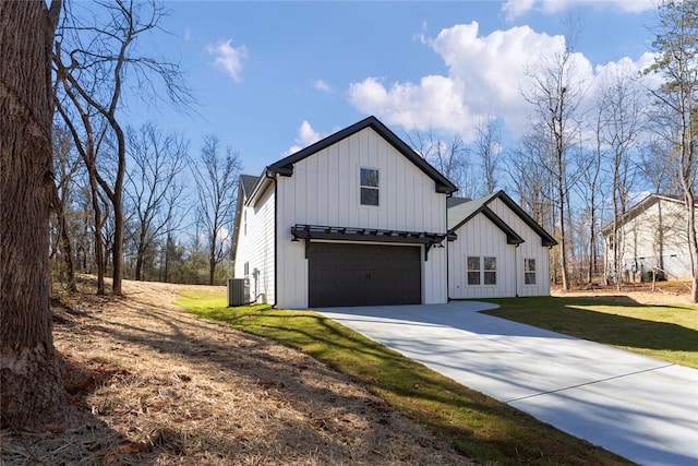 modern inspired farmhouse featuring central air condition unit, concrete driveway, an attached garage, board and batten siding, and a front yard