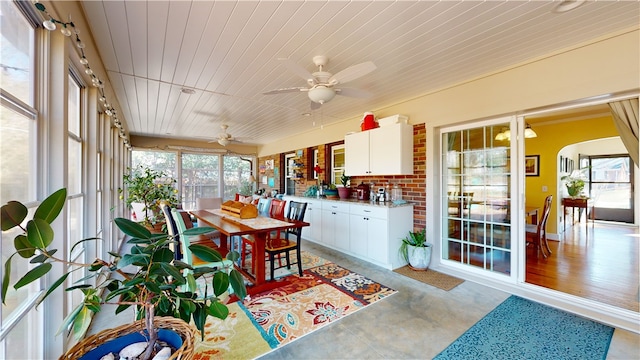 sunroom / solarium with wood ceiling and ceiling fan