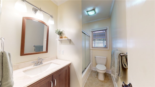 full bathroom with crown molding, toilet, combined bath / shower with glass door, vanity, and tile patterned floors