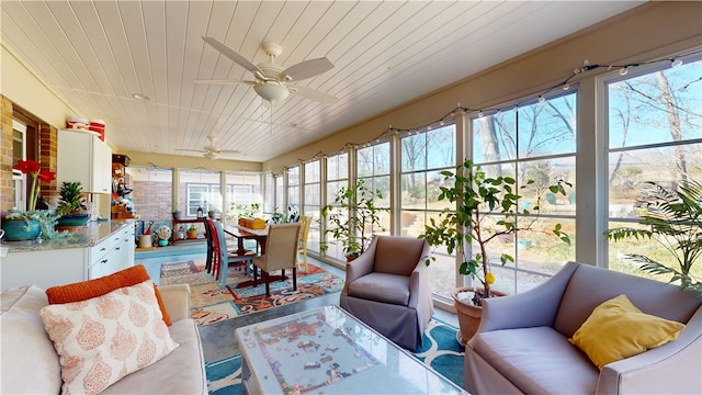 sunroom / solarium with wooden ceiling and a ceiling fan