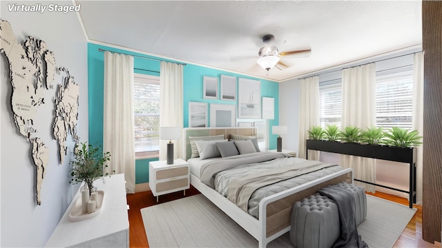 bedroom with ornamental molding, ceiling fan, and wood finished floors