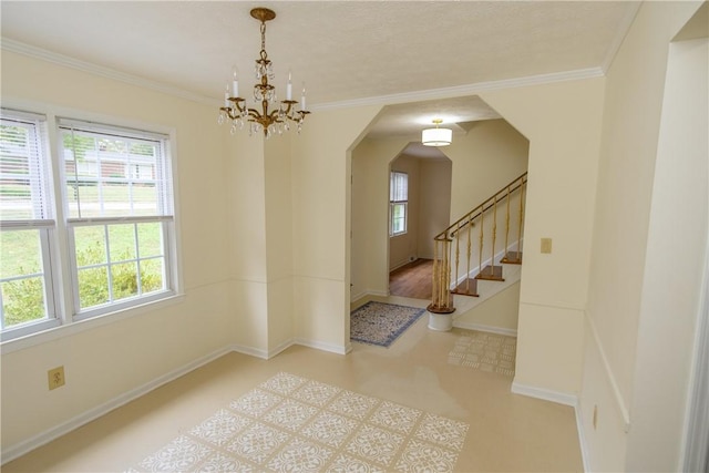 interior space with stairway, tile patterned floors, a wealth of natural light, and crown molding