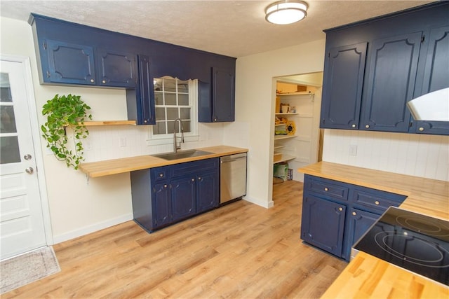 kitchen with butcher block countertops, a sink, stainless steel dishwasher, and blue cabinets