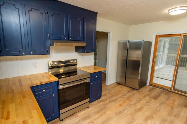 kitchen with blue cabinets, under cabinet range hood, butcher block countertops, and stainless steel appliances