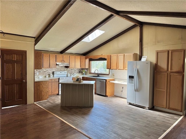 271 Piper Ln, Pickens, SC 29671 - kitchen featuring white appliances, a skylight, under cabinet range hood, light wood-style floors, and a center island