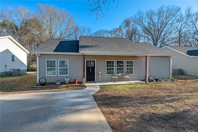 view of front of house featuring central air condition unit and a shingled roof