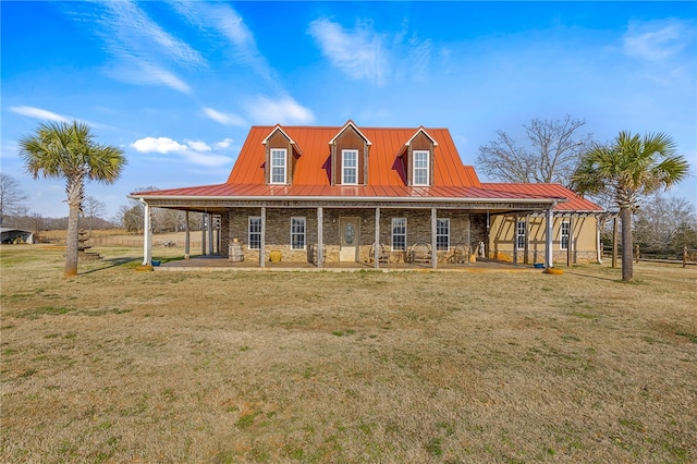 farmhouse inspired home featuring a standing seam roof, stone siding, metal roof, and a front yard