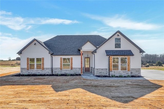 modern inspired farmhouse with stone siding and roof with shingles