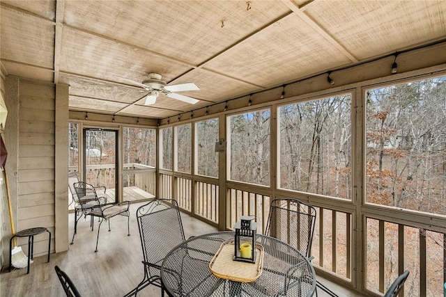 unfurnished sunroom with wooden ceiling and ceiling fan