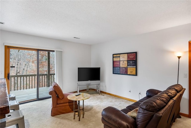 living area featuring a textured ceiling, baseboards, visible vents, and light colored carpet