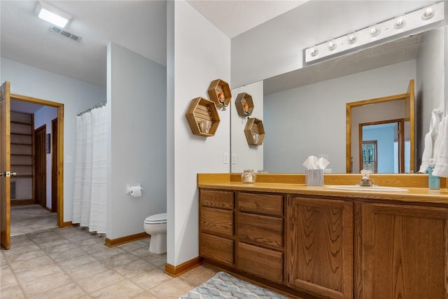 bathroom featuring toilet, vanity, visible vents, baseboards, and a shower with curtain