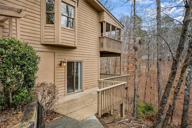 back of property featuring a balcony and stucco siding