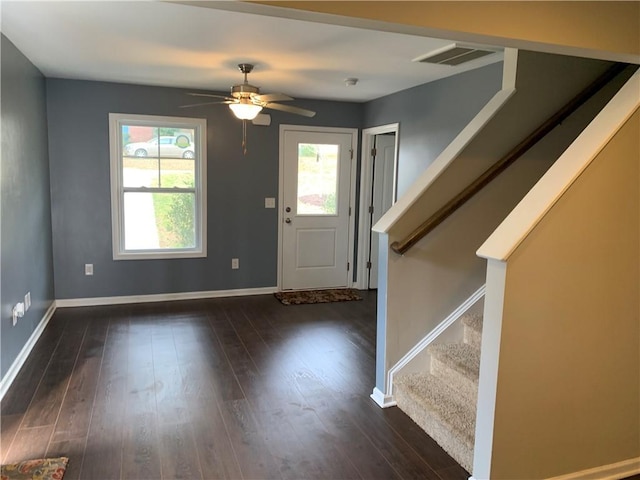 foyer entrance with baseboards, stairs, visible vents, and dark wood-style flooring