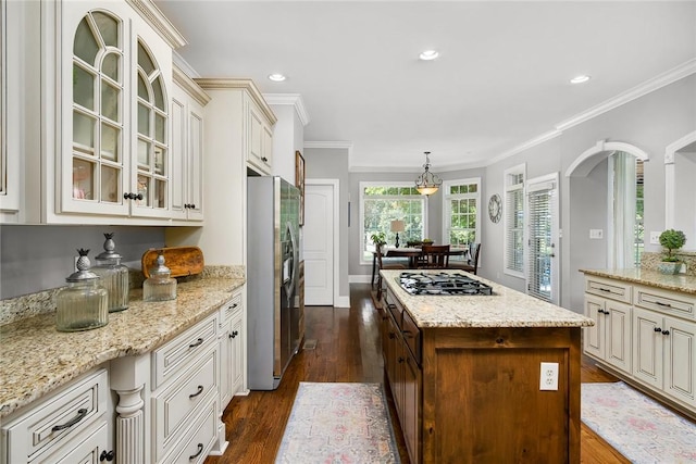 kitchen featuring stainless steel appliances, light stone countertops, dark wood-style floors, glass insert cabinets, and crown molding