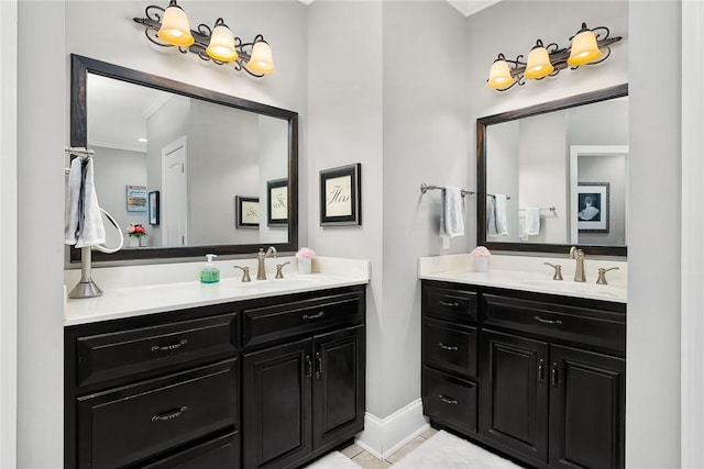 full bathroom with tile patterned flooring, baseboards, two vanities, and a sink