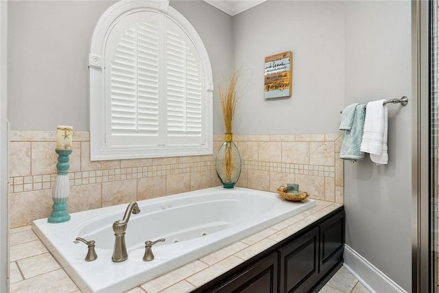 bathroom with a whirlpool tub, baseboards, and tile patterned floors