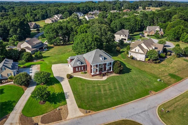 birds eye view of property with a wooded view and a residential view