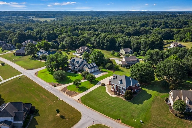 birds eye view of property with a residential view and a wooded view