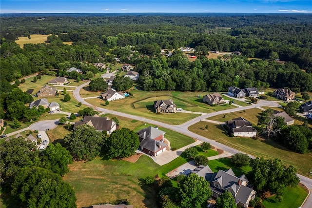 birds eye view of property featuring a forest view and a residential view