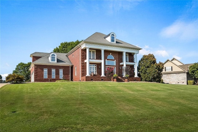 neoclassical home featuring a front lawn, crawl space, and brick siding