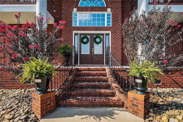 property entrance with french doors and brick siding