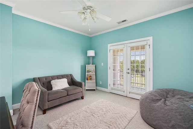 sitting room with french doors, visible vents, ornamental molding, carpet flooring, and baseboards