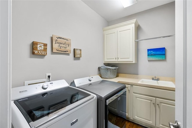 clothes washing area featuring cabinet space, a sink, and independent washer and dryer