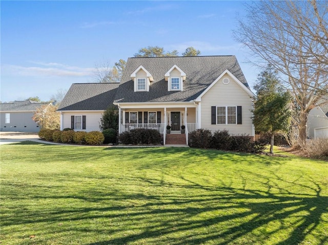 new england style home featuring covered porch and a front lawn