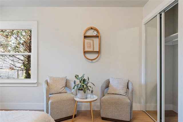 interior space featuring multiple windows, light wood-style flooring, and baseboards