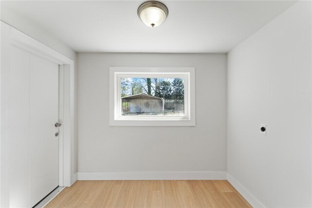 empty room with light wood-type flooring and baseboards