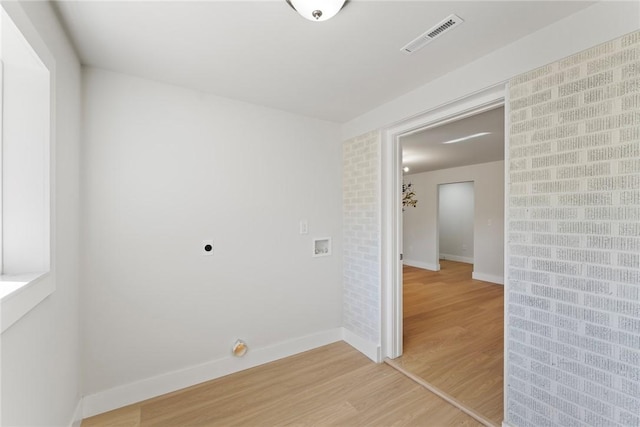 unfurnished room with light wood finished floors, baseboards, and visible vents