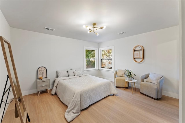 bedroom featuring light wood-type flooring, baseboards, and visible vents