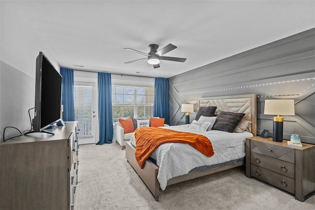 bedroom featuring light carpet and ceiling fan