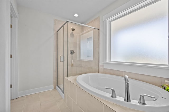 bathroom featuring baseboards, a stall shower, tile patterned flooring, and a bath